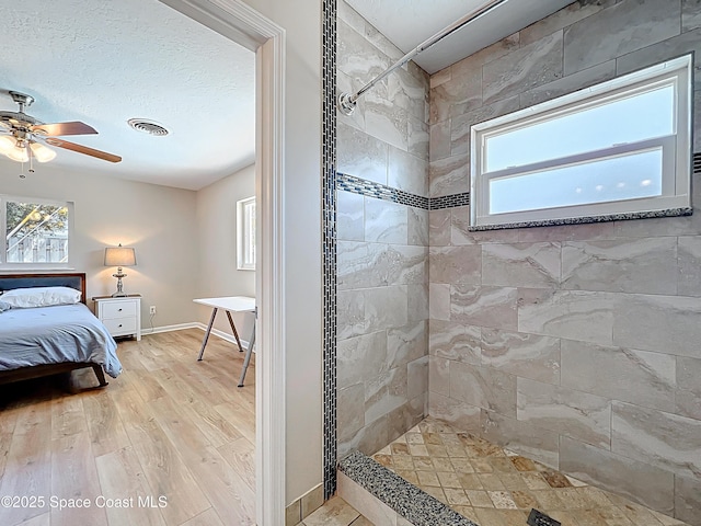 ensuite bathroom featuring ensuite bath, a tile shower, a wealth of natural light, and visible vents