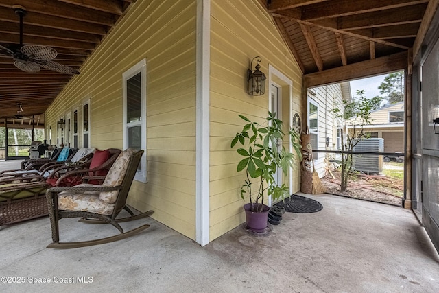 exterior space featuring wood ceiling, vaulted ceiling with beams, and plenty of natural light