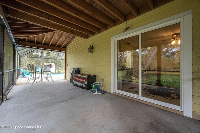 view of patio featuring a pool and glass enclosure