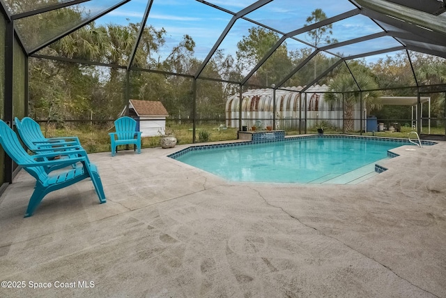 view of pool with a lanai, a shed, and a patio area