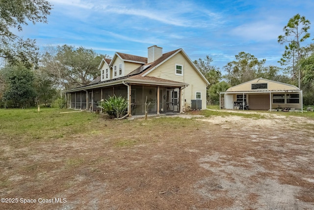 back of property with central air condition unit and a sunroom