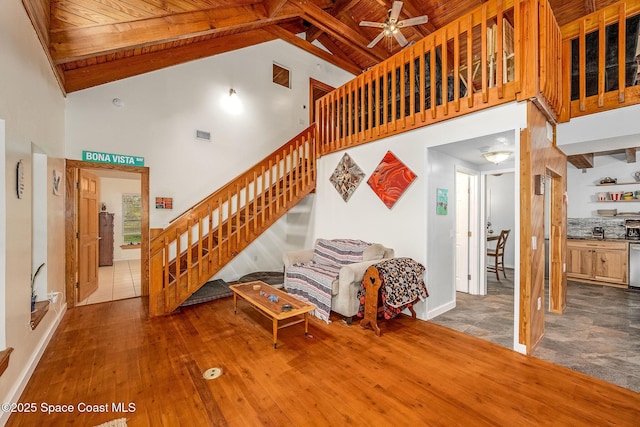 living room with high vaulted ceiling, ceiling fan, and wood ceiling