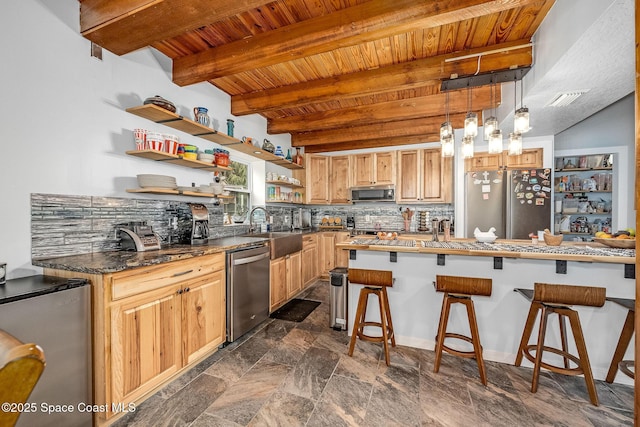 kitchen with stainless steel appliances, light brown cabinets, a kitchen bar, beamed ceiling, and sink