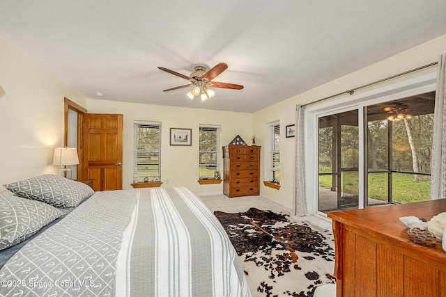 tiled bedroom featuring ceiling fan and access to outside