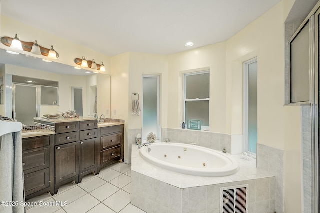 bathroom with vanity, plus walk in shower, and tile patterned floors