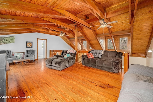 living room featuring lofted ceiling with beams, light wood-type flooring, ceiling fan, and wood ceiling