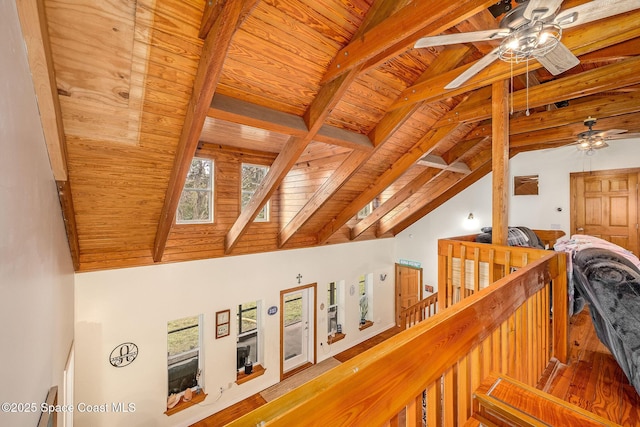 hallway featuring lofted ceiling with beams and wooden ceiling