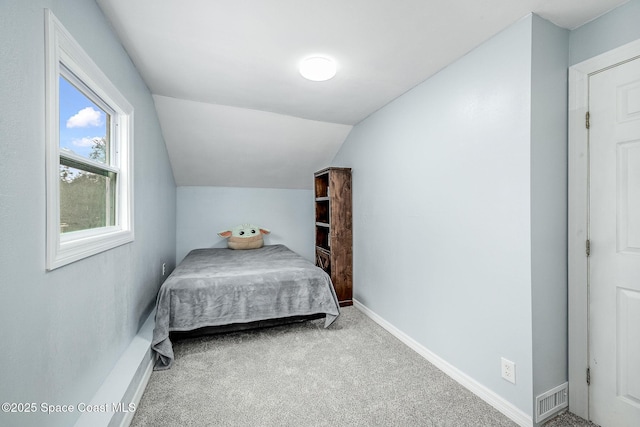 carpeted bedroom featuring vaulted ceiling