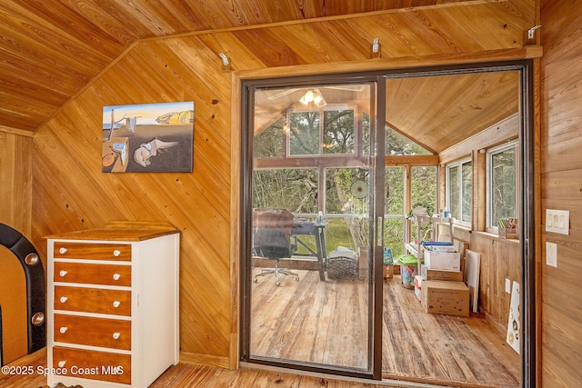 doorway to outside with lofted ceiling, wood walls, hardwood / wood-style flooring, and wood ceiling