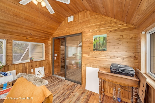 interior space featuring lofted ceiling, ceiling fan, wood ceiling, and plenty of natural light