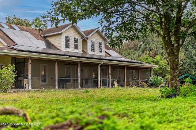 view of front of home with solar panels and a sunroom