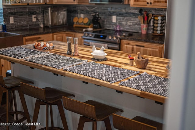 kitchen with a breakfast bar and black range oven