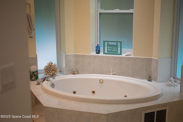 bathroom with a relaxing tiled tub