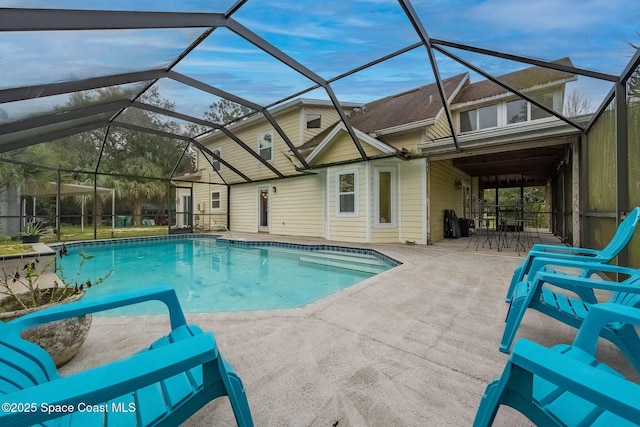 view of pool featuring a patio and glass enclosure