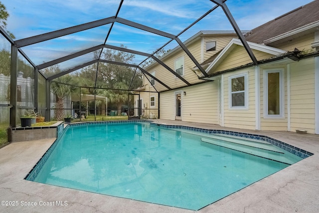 view of pool with a lanai and a patio