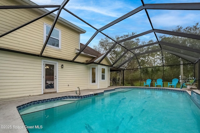 view of swimming pool with a lanai