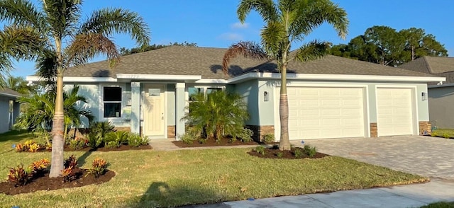 view of front of property with a front yard and a garage