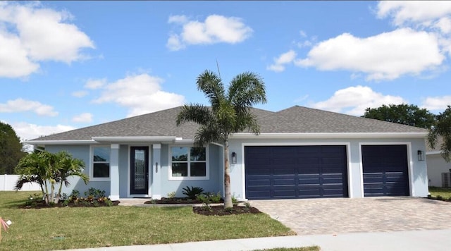 single story home with a front lawn and a garage