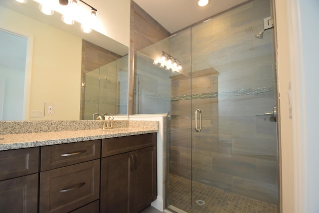 bathroom with vanity and an enclosed shower