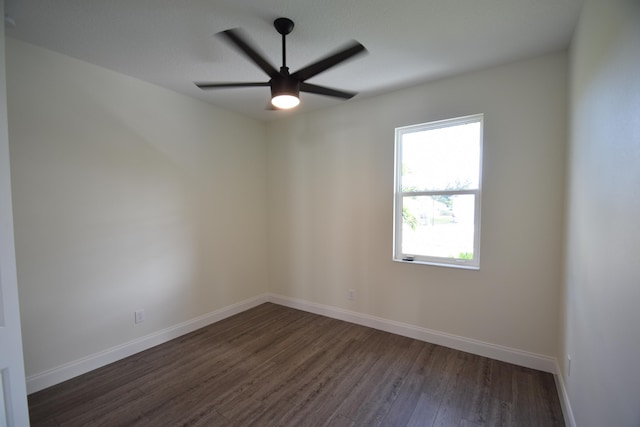 unfurnished room with dark hardwood / wood-style flooring and ceiling fan