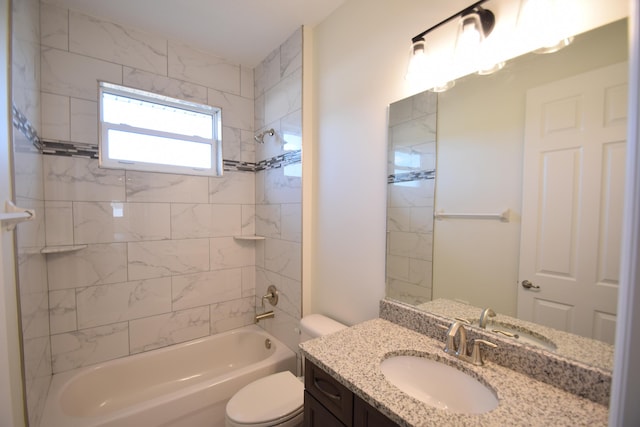 full bathroom featuring tiled shower / bath combo, toilet, and vanity