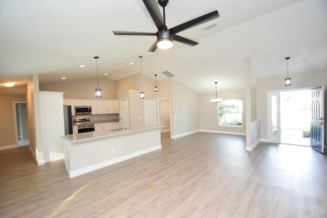 kitchen with white cabinetry, sink, stainless steel appliances, an island with sink, and decorative light fixtures