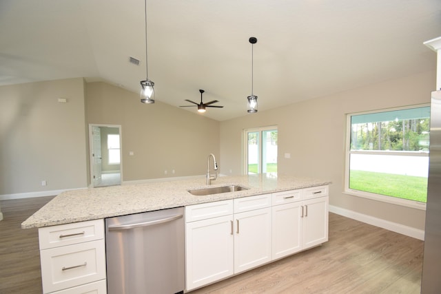 kitchen featuring sink, hanging light fixtures, vaulted ceiling, stainless steel dishwasher, and white cabinetry