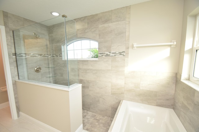 bathroom with plus walk in shower and tile patterned flooring