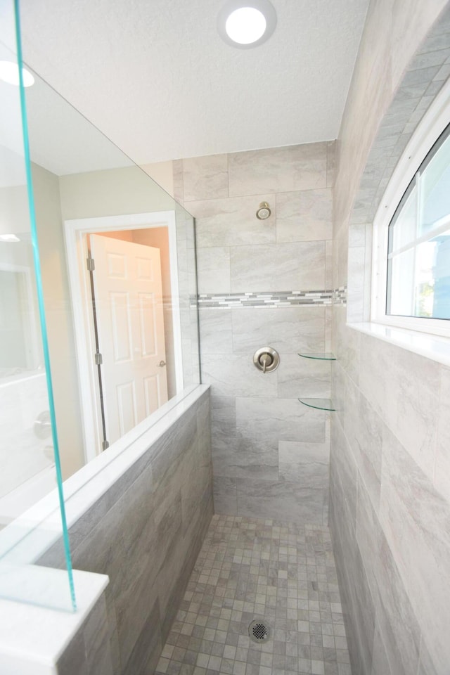 bathroom with a tile shower