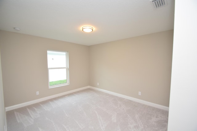 unfurnished room with light carpet