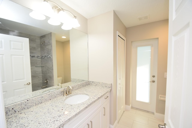 bathroom featuring a shower, vanity, and tile patterned floors