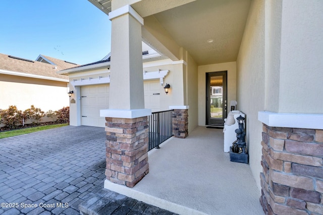 view of patio / terrace featuring a porch and a garage