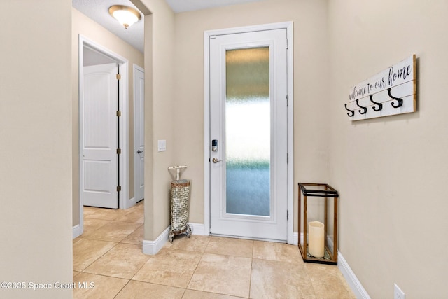 doorway with light tile patterned floors