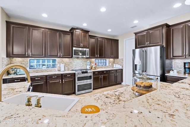 kitchen featuring dark brown cabinets and stainless steel appliances