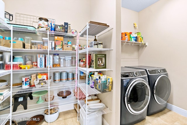 laundry room featuring independent washer and dryer and light tile patterned floors