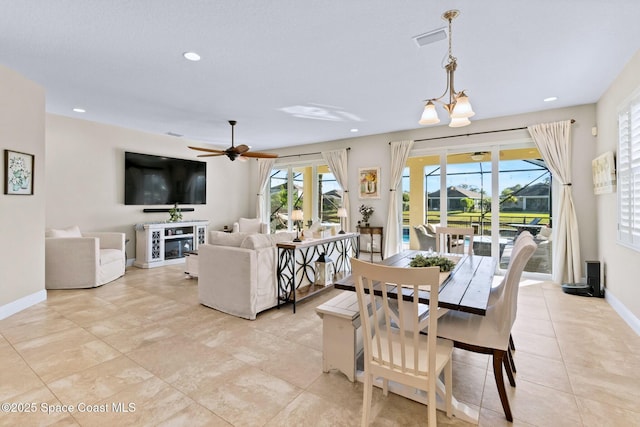 dining area featuring ceiling fan with notable chandelier