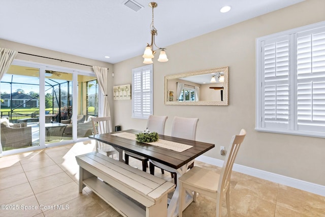 dining area featuring light tile patterned floors and a notable chandelier