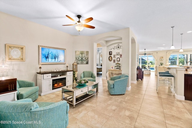 tiled living room with ceiling fan