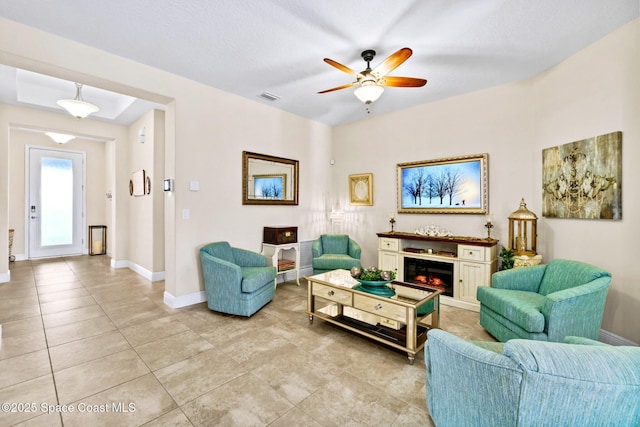 tiled living room with ceiling fan