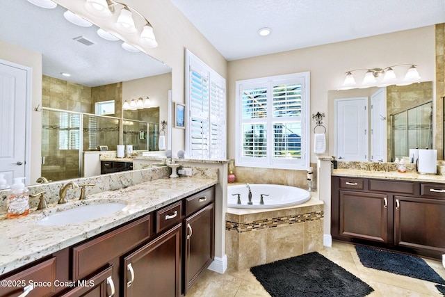 bathroom with tile patterned flooring, vanity, and shower with separate bathtub