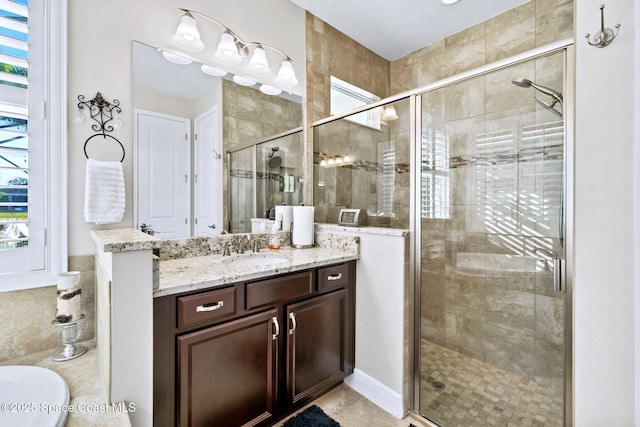 bathroom featuring vanity and an enclosed shower