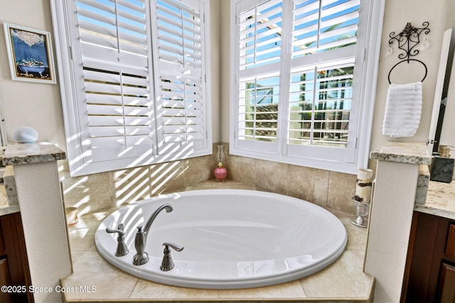 bathroom with vanity and a relaxing tiled tub