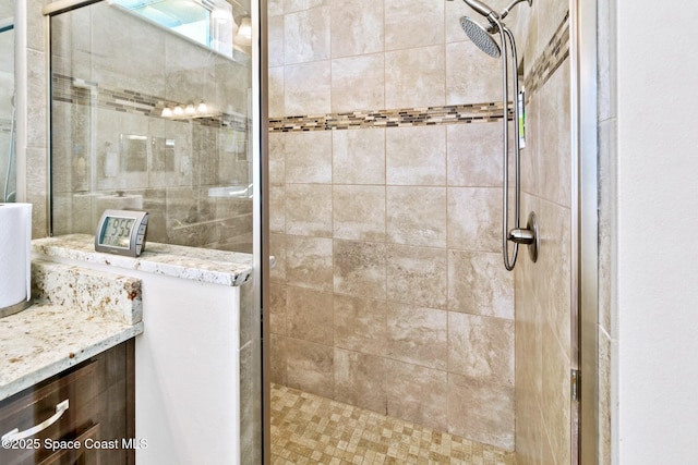 bathroom with vanity and tiled shower