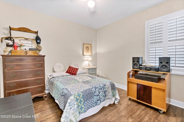 bedroom with ceiling fan and dark hardwood / wood-style flooring