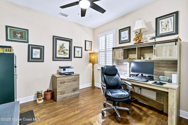 office space with ceiling fan and dark wood-type flooring