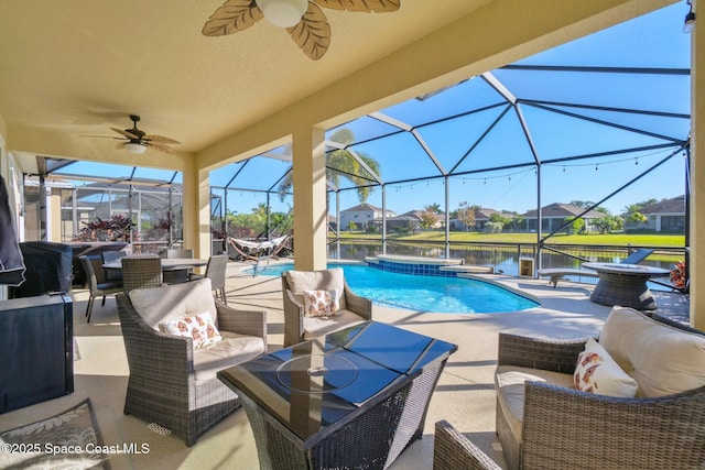 view of swimming pool featuring outdoor lounge area, a water view, glass enclosure, and a patio area