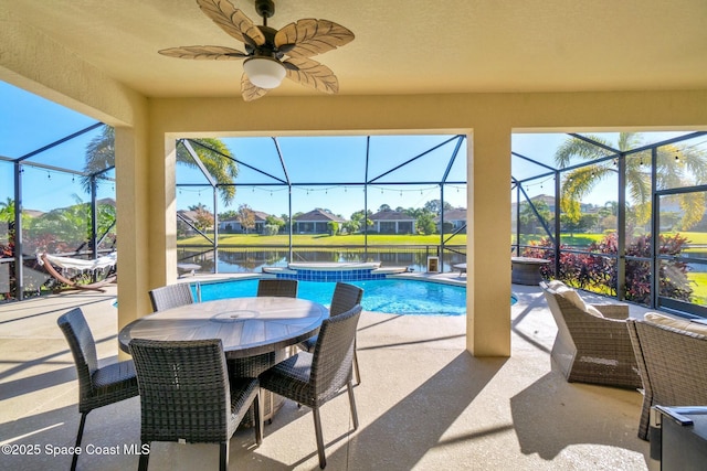 view of pool with a water view, ceiling fan, a lanai, an in ground hot tub, and a patio