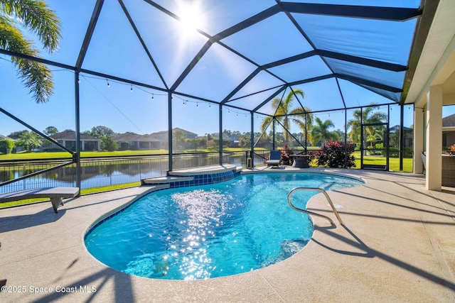 view of pool with glass enclosure, a patio area, and a water view