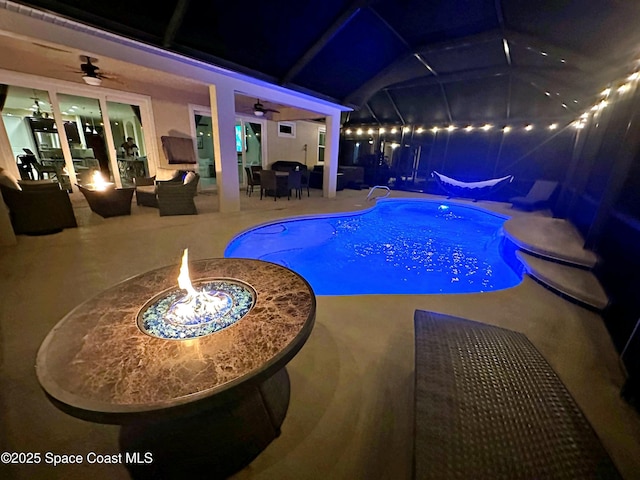 view of pool featuring ceiling fan, a patio area, and an outdoor fire pit