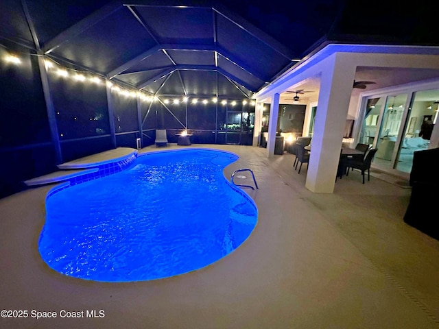 view of pool featuring a lanai, a patio area, and ceiling fan